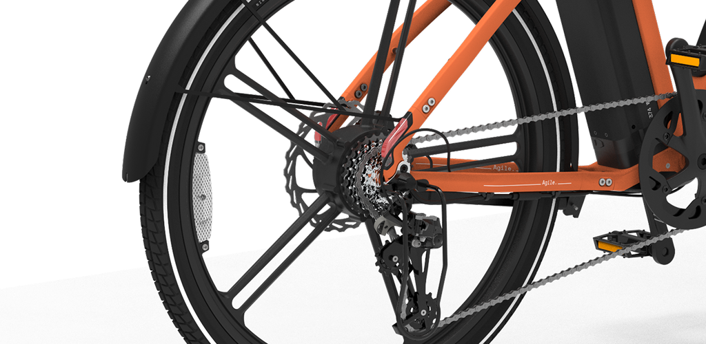 Rear wheel of an orange NINE09 electric bike with integrated tail light and drivetrain